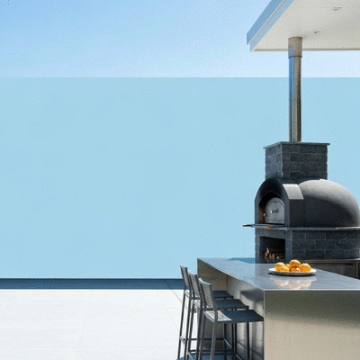 A beautifully designed outdoor kitchen with a pizza oven
